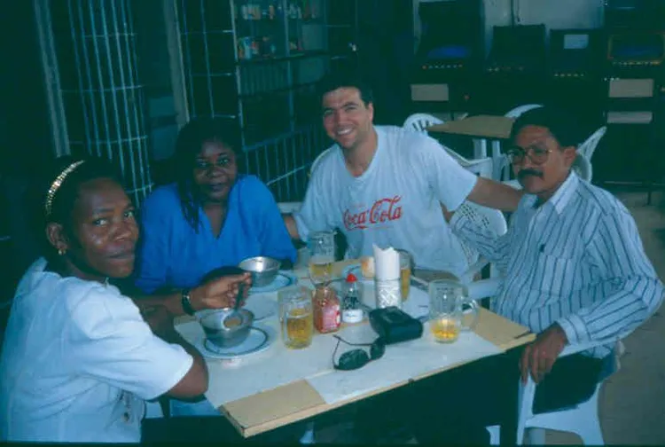 Tolla Lombard between his host in Luanda, Diamantino dos Santo, and Diamanto's wife Fatima, and a friend.